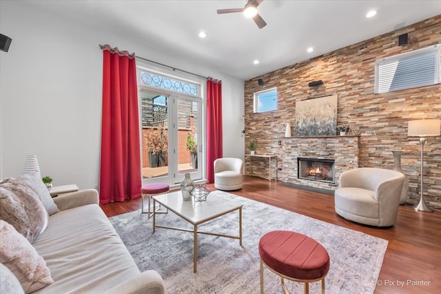 living room featuring recessed lighting, a ceiling fan, wood finished floors, and a fireplace