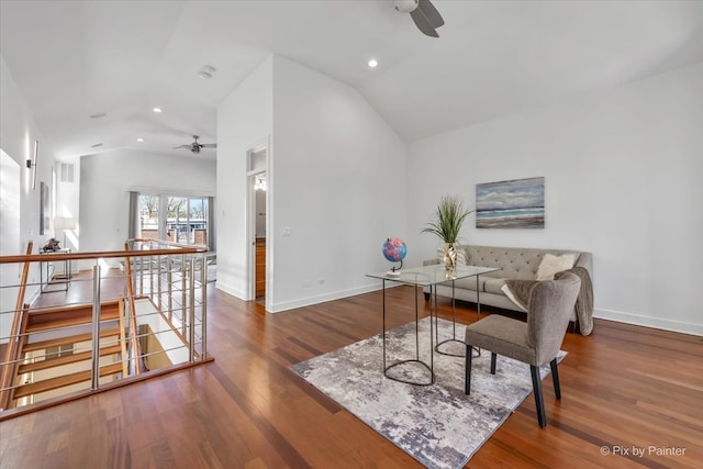 office area featuring ceiling fan, vaulted ceiling, baseboards, and wood finished floors