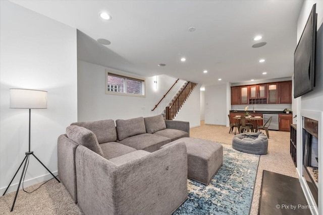 living room featuring recessed lighting, baseboards, and stairway