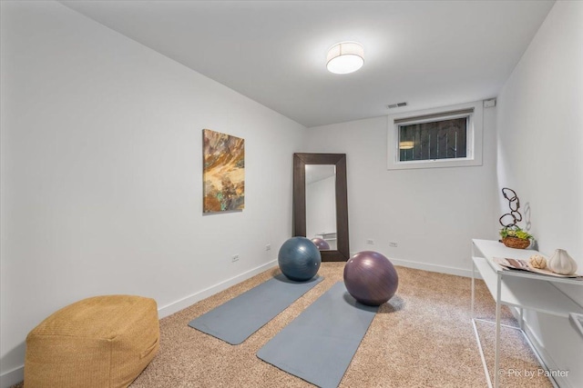 exercise room featuring carpet floors, baseboards, and visible vents