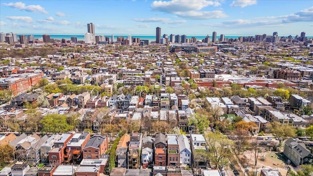 aerial view with a residential view, a view of city, and a water view