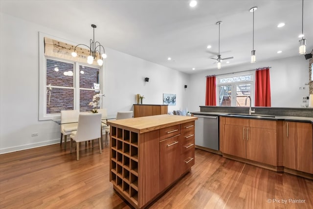 kitchen with stainless steel dishwasher, open shelves, a sink, light wood finished floors, and wood counters