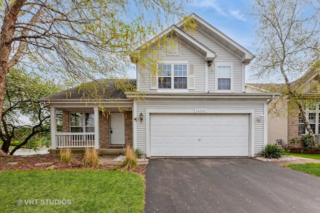 14252 S Hemingway Cir, Plainfield, IL 60544 - traditional-style home with covered porch, an attached garage, and driveway