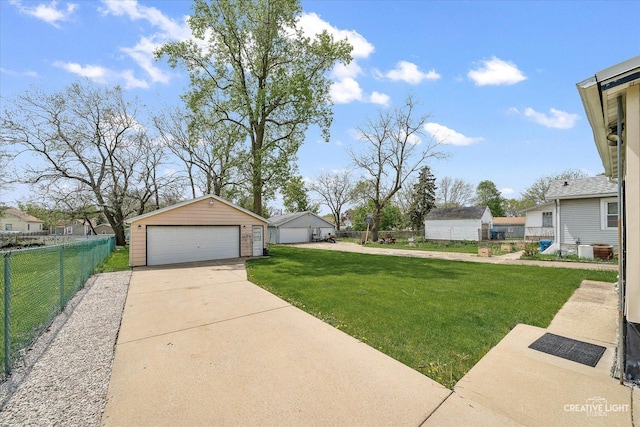 view of yard featuring a garage and an outdoor structure