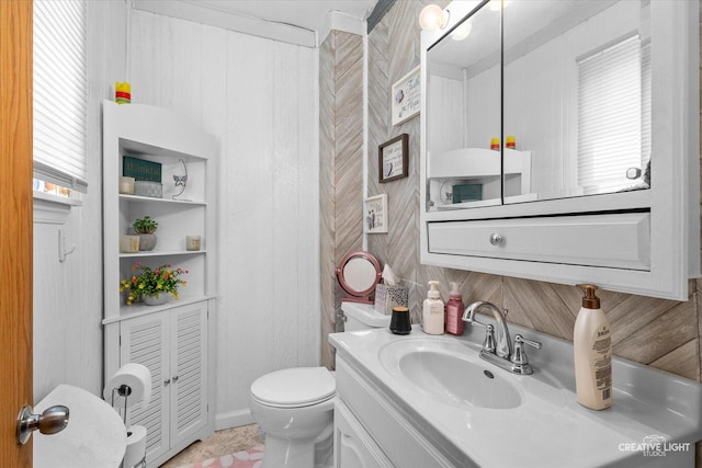 bathroom with toilet and vanity
