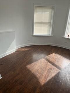 spare room with wood finished floors and baseboards