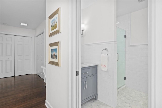 273 Eaton St, Northfield, IL 60093 - hallway featuring tile walls, wainscoting, and wood finished floors