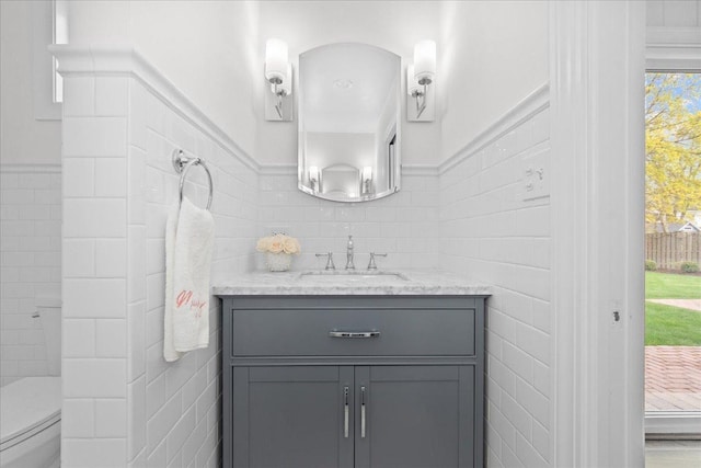 273 Eaton St, Northfield, IL 60093 - bathroom featuring toilet, tile walls, and vanity