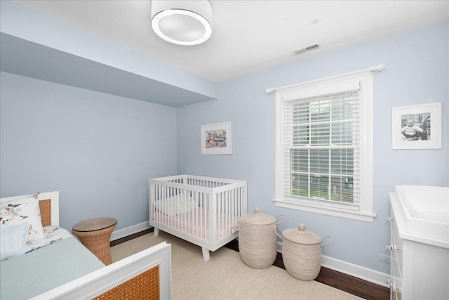 273 Eaton St, Northfield, IL 60093 - bedroom with baseboards, visible vents, and wood finished floors