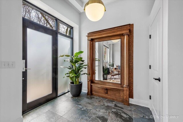 doorway to outside with baseboards