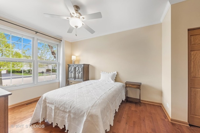 1178 Drury Ln, Aurora, IL 60502 - bedroom with baseboards, wood finished floors, crown molding, and a ceiling fan