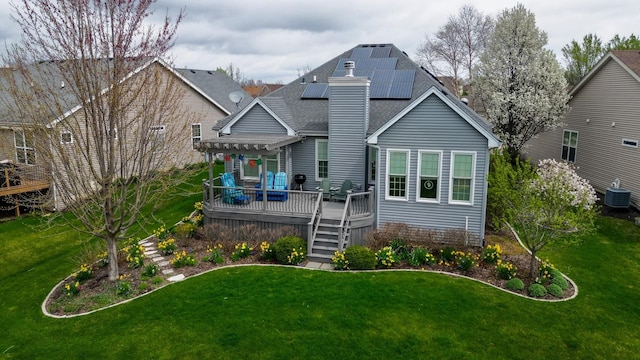 1178 Drury Ln, Aurora, IL 60502 - rear view of property with a chimney, solar panels, a yard, a deck, and central AC unit