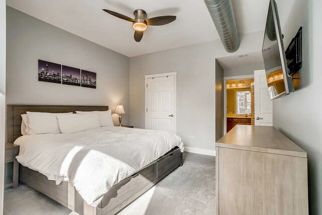 bedroom featuring baseboards, concrete flooring, ensuite bath, and ceiling fan