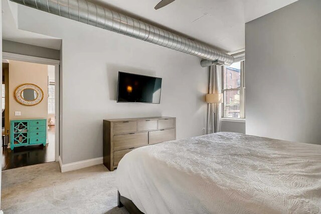 bedroom with carpet floors and baseboards