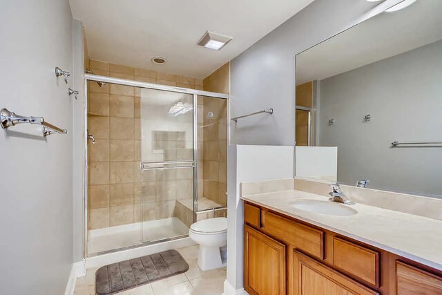 full bath with vanity, toilet, tile patterned flooring, and a stall shower