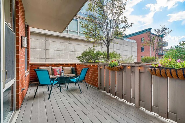wooden deck with an outdoor living space