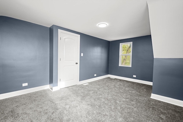 empty room with baseboards and carpet