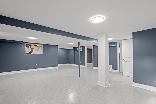 finished below grade area featuring baseboards and visible vents