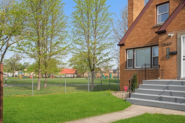 view of yard with fence and a playground