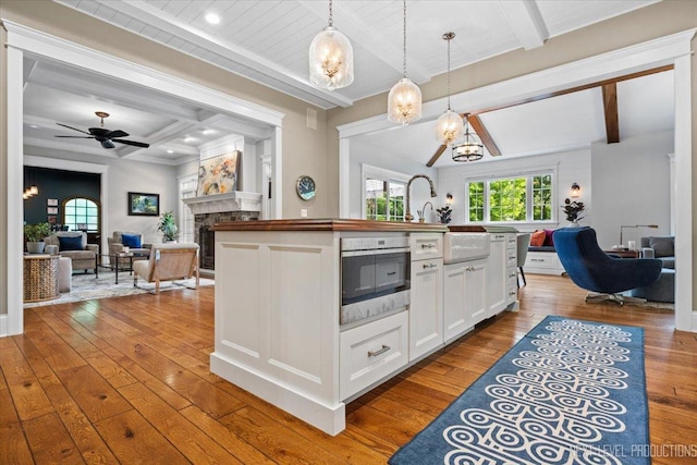 7S361 Arbor Dr, Naperville, IL 60540 - kitchen featuring beam ceiling, open floor plan, hardwood / wood-style floors, and a fireplace