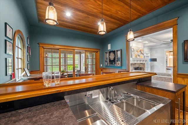 7S361 Arbor Dr, Naperville, IL 60540 - bar with wood ceiling, wainscoting, decorative light fixtures, a fireplace, and a sink
