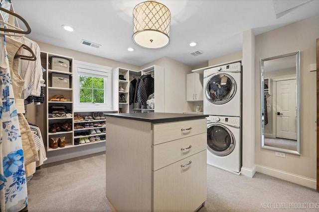 7S361 Arbor Dr, Naperville, IL 60540 - clothes washing area with visible vents, stacked washer / dryer, cabinet space, and light colored carpet