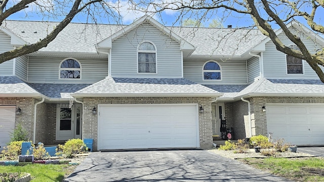 2205 Daffodil Dr, Crest Hill, IL 60403 - view of front of house featuring asphalt driveway, an attached garage, brick siding, and a shingled roof