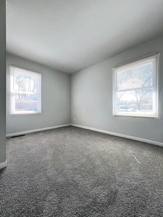 unfurnished room featuring baseboards and carpet flooring