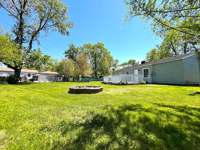 view of yard featuring a fire pit and a wooden deck