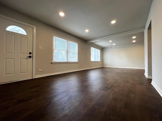 foyer entrance with dark wood-type flooring, baseboards, and recessed lighting