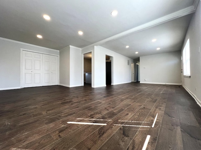 unfurnished living room with dark wood-style flooring, ornamental molding, recessed lighting, and baseboards