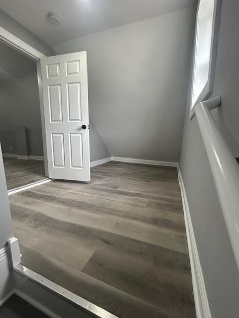 empty room with wood finished floors and baseboards