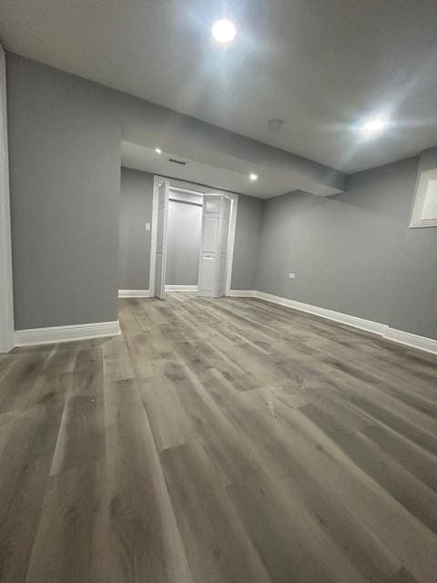 unfurnished bedroom with baseboards, recessed lighting, and wood finished floors
