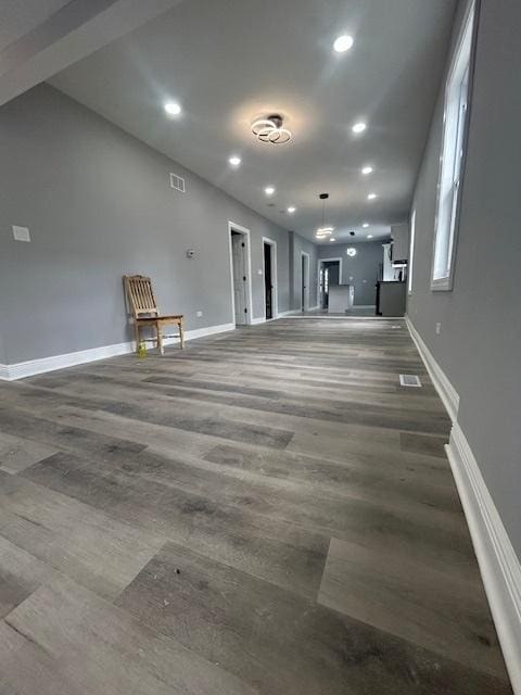 interior space with baseboards, recessed lighting, and wood finished floors