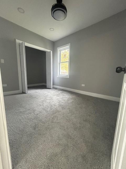 unfurnished bedroom with carpet flooring and baseboards