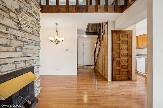 23460W N Lakewood Ln, Lake Zurich, IL 60047 - interior space featuring baseboards, an inviting chandelier, stairway, a fireplace, and light wood-type flooring