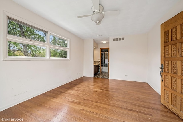 23460W N Lakewood Ln, Lake Zurich, IL 60047 - empty room featuring visible vents, light wood-style flooring, baseboards, and ceiling fan