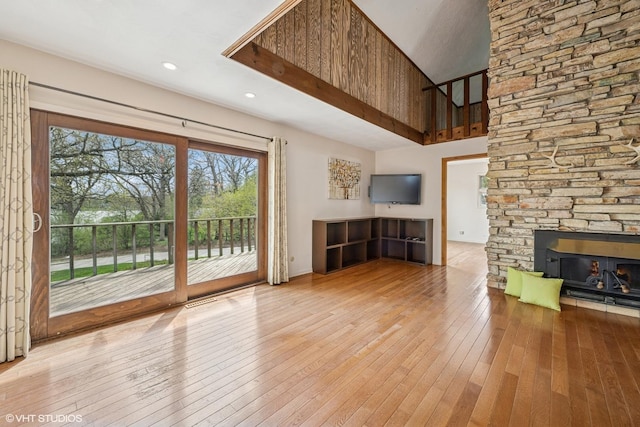 23460W N Lakewood Ln, Lake Zurich, IL 60047 - unfurnished living room with a stone fireplace, recessed lighting, wood-type flooring, and a towering ceiling