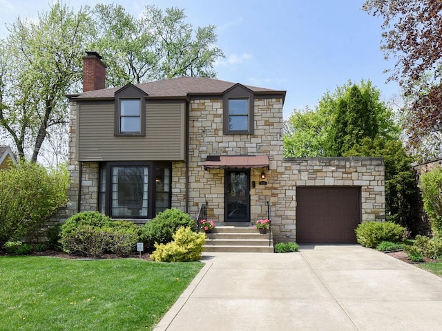 view of front of house featuring a chimney, a front yard, a garage, concrete driveway, and stone siding