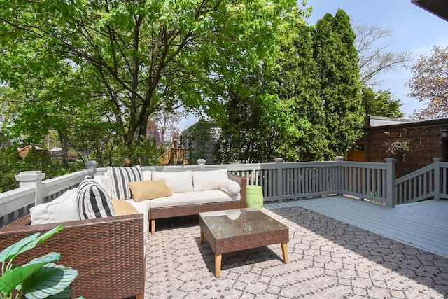 wooden terrace with an outdoor living space
