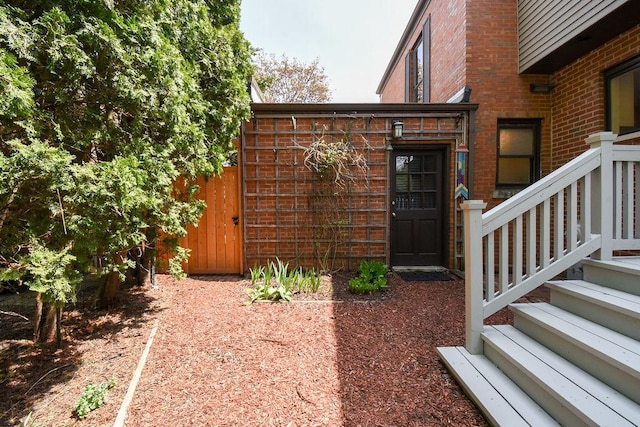 property entrance featuring brick siding