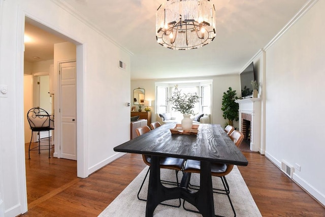 dining room with visible vents, wood finished floors, and a chandelier