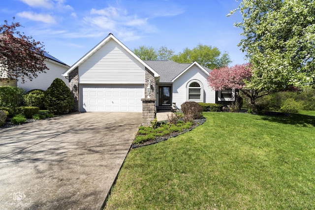 single story home featuring driveway, a front yard, and a garage