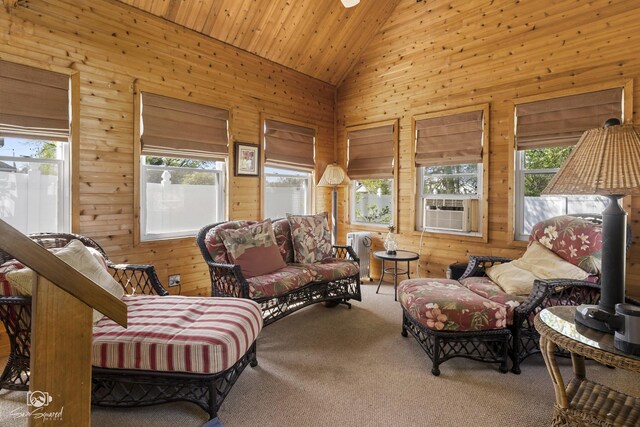 carpeted living area with wood walls, cooling unit, high vaulted ceiling, and wooden ceiling