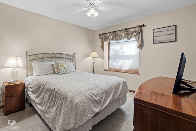 carpeted bedroom featuring baseboards and a ceiling fan