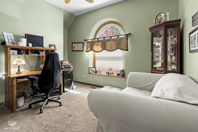 home office with baseboards, a ceiling fan, lofted ceiling, and carpet