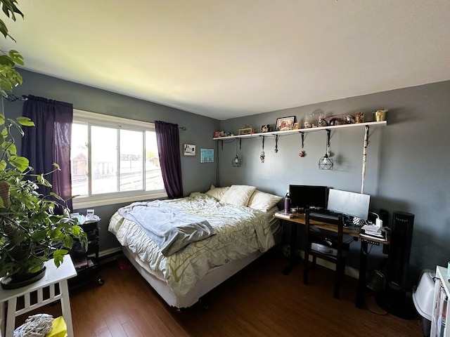 bedroom featuring wood finished floors and a desk