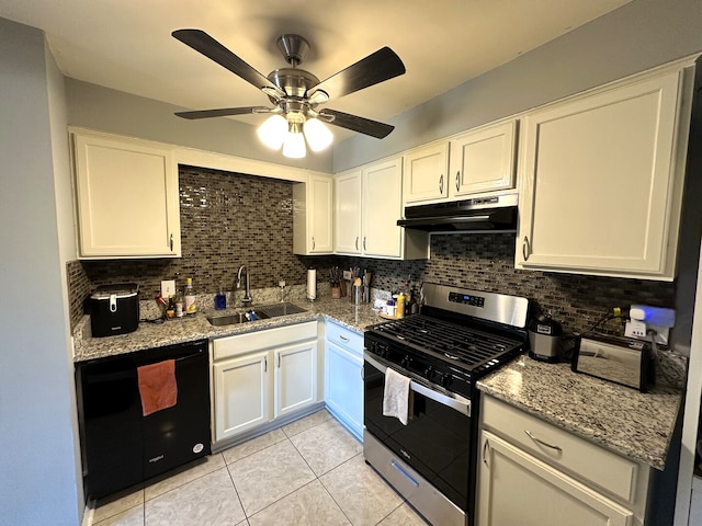 kitchen featuring stainless steel range with gas cooktop, under cabinet range hood, a sink, black dishwasher, and backsplash