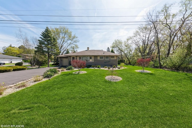 635 N Greenleaf St, Gurnee, IL 60031 - view of yard with a garage and aphalt driveway