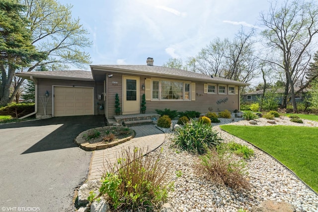 635 N Greenleaf St, Gurnee, IL 60031 - view of front of home featuring an attached garage, a chimney, and driveway